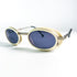 Plan rapproché lunettes de soleil Courrèges G100 monture ivoire et verres bleus